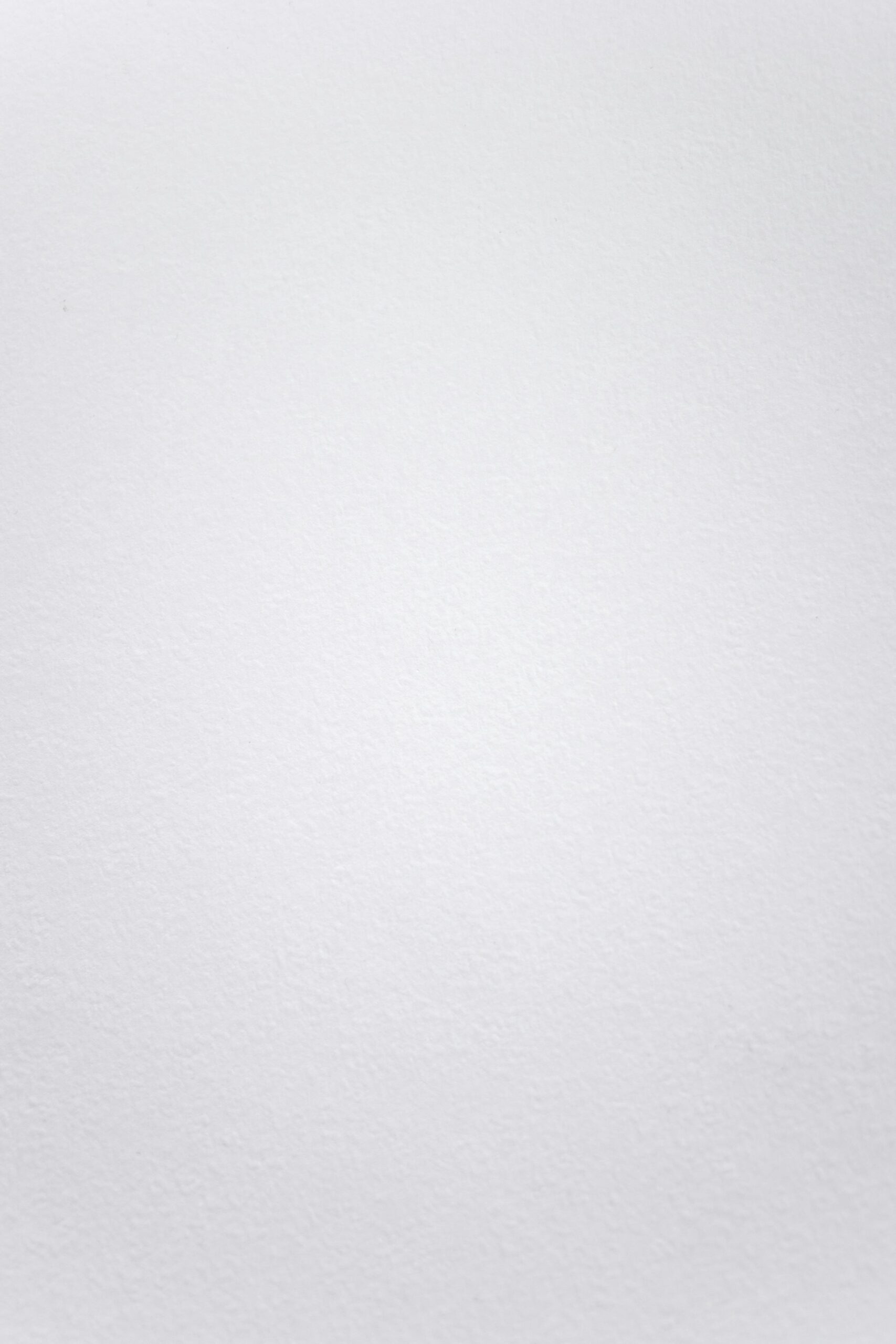 A smooth white textured background suitable for minimalistic design projects.